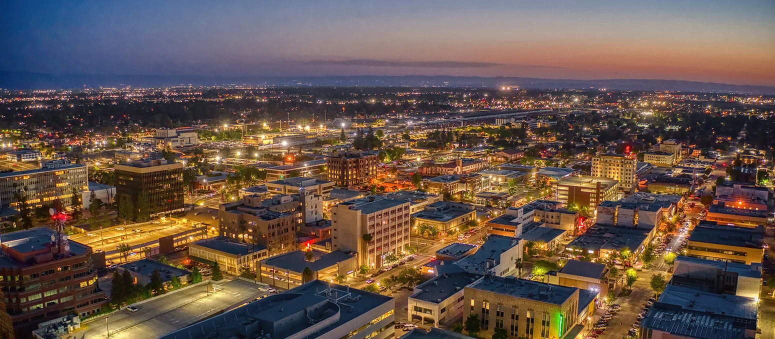 Aerial photograph of Bakersfield city lights at dusk, supplied for the website